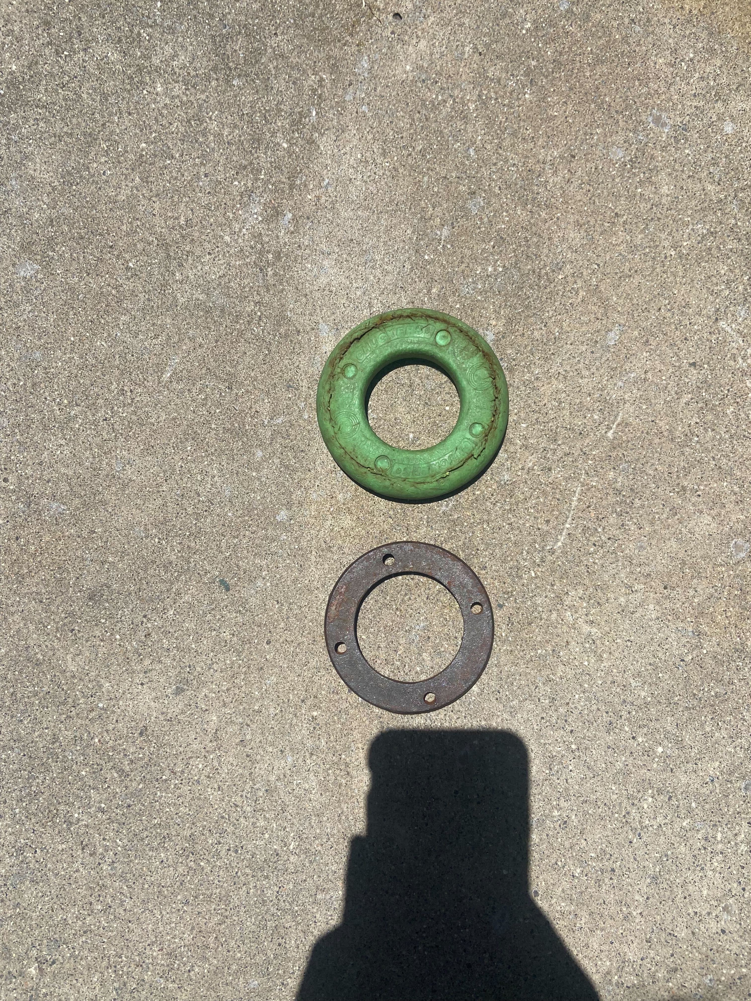 Top view of a green rubber-coated Chuckers ring next to the metal core.